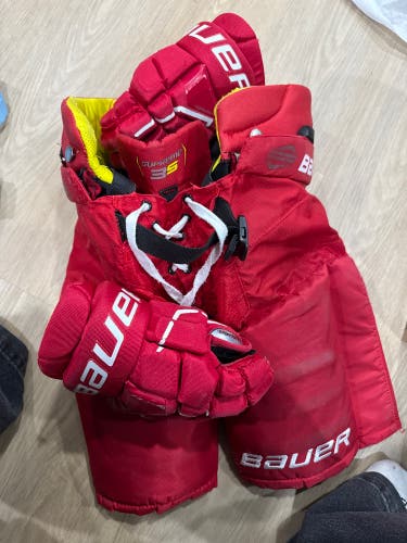 Junior Medium custom red Bauer Supreme Mach Hockey Pants and size 11 custom red gloves in a set