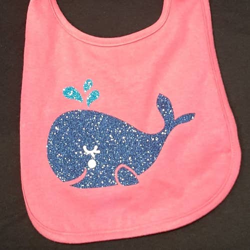 CHILDREN'S BIB. HOT PINK/BLUE GLITTER FLAKE WHALE