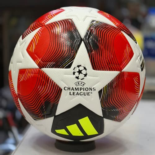 Champions League 2025/26 football with red, black, and white panels with curved lines
