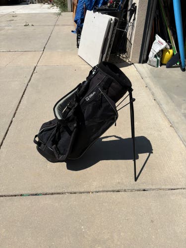 Golf Bag: Wilson golf stand bag features a black mesh design and a single carry strap