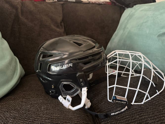 Medium Bauer Re-Akt 150 Helmet with white cage. (Both used)