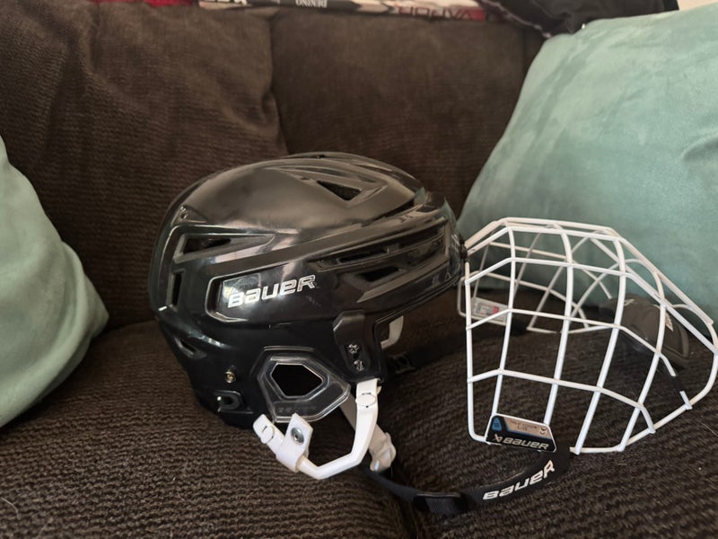 Medium Bauer Re-Akt 150 Helmet with white cage. (Both used)