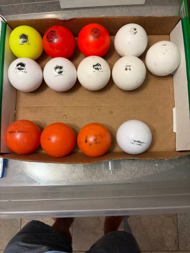 13 used field hockey balls