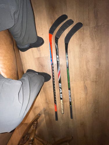 Bundle of 3 small hockey sticks.