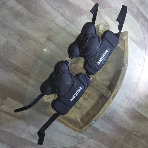 pair of black Vaughn goalie knee and thigh guards
