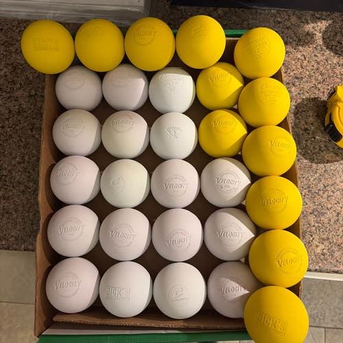 30 Pack of Brand New Assorted white and yellow lacrosse balls.