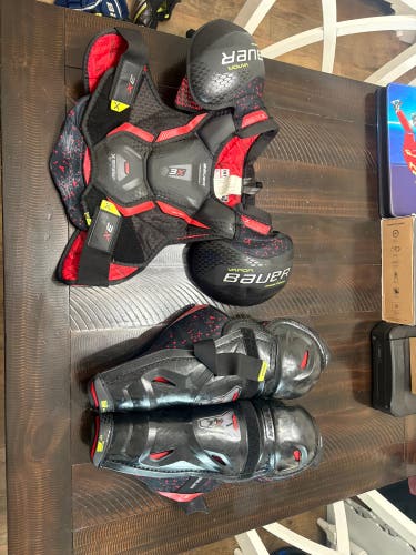 Large Intermediate Bauer Vapor 3X Shoulder Pads (Used), and 14 inch intermediate 3X shin pads (used)